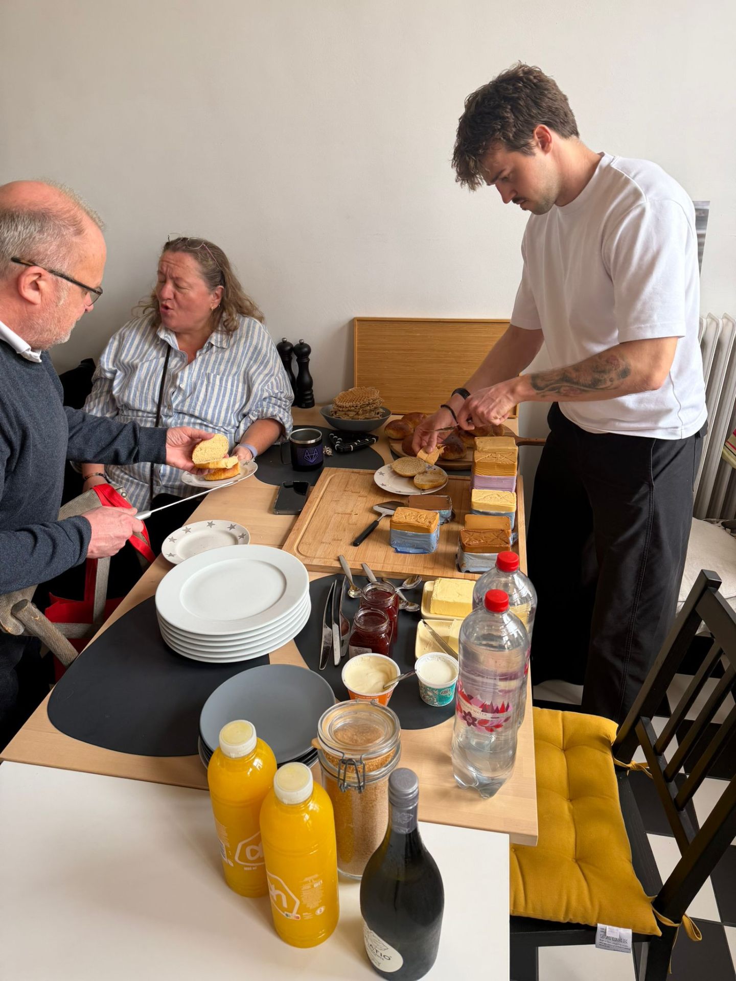 Greg at a friend's table tasting Norwegian brunost