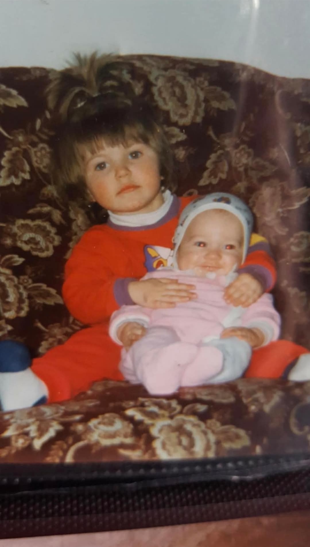 My sister holding baby me